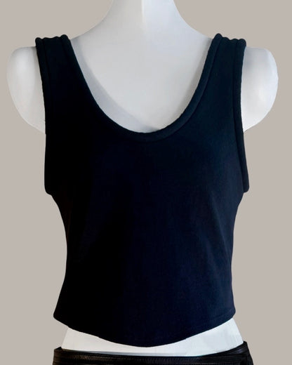 Black tank top on a mannequin against a neutral background